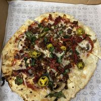 Sundried tomatoes, mushrooms, spinach, and jalapeños, plus zero sausage .  at Azzip Pizza in Indianapolis
