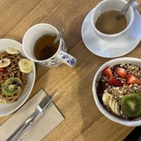 Breakfast with waffles, acai bowl, tea, milk coffee (plantbased milk)  at Zer0 in Manacor