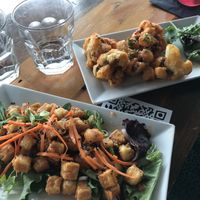 Tofu bites and half eaten wings  at The Charlatan in Vancouver