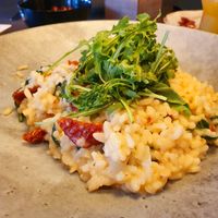 Leaf spinach risotto with dried tomatoes and rocket (vegan) at Unikat in Cuxhaven