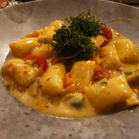 Gnocchi with cherry tomatoes, avocado, pumpkin and fried rocket (vegan) at Unikat in Cuxhaven