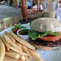 The la montaña burger with olive/rosemary bun. The garlic sauce was amazing as a dip for our fries. at Indómitos Café & Bar in Uvita