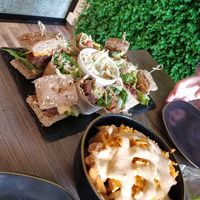Platter of different sliders, coleslaw, and "cheesey" chips. at Elysian Restaurant in Nicosia