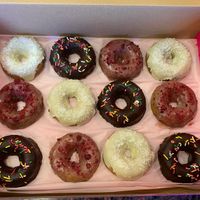 Mixed donut box with chocolate, strawberry, and coconut donuts at Giselle's Vegan Kitchen in Laguna Hills