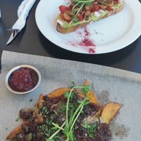 Vegetarian baked potato dish with mushrooms and cranberries and in the back vegan avocado sandwich. at IBA.TU Bistro in Vysoke Tatry