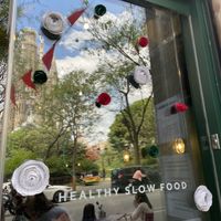 Window decorated for St Jorge’s Day, with Sagrada Família in the reflection  at Green&Burger - Biocenter in Barcelona