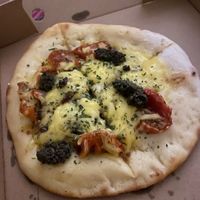 Fully loaded vegan garlic bread with sun-dried tomatoes vegan cheese and tapenade at The Dead Pigeon in Rochester