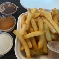 Fries with three choices of vegan sauces at The Dead Pigeon in Rochester