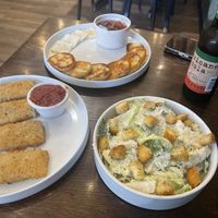Mozzarella sticks (left), bruschetta (center), and Caesar salad (right)  at Pizza Verde in Fort Worth