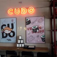 Interior with funky posters and nice neon at Cudo Vegan Sushi in Poznan