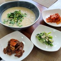 Perilla seed soup (with noodles), along with some of the side dishes served with the meal at Soban Vegan 소반 비건식당 in Busan