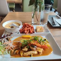 Coconut soup, tofu with mango dressing, sweet potato fries and dessert at Vevi in Vienna