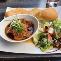 Vietnamese Goulash with salad and baguette at Vevi in Vienna