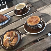 A delightful breakfast spot! Spiced latte and Americano with cinnamon swirl bun and croissant in the sunny courtyard!   at Loaf Sourdough Bakery in Utrecht