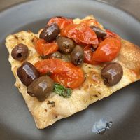 Olive and tomato pizza at Prima la Materia in Rome