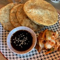 Huushuur: Mongolian deep fried dough pockets 😍 and an amazing Kimchi!  at Veganaa in Berlin