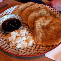 Mongolische Teigtaschen mit Kartoffelsalat als Beilage at Veganaa in Berlin