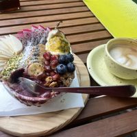 Strawberry açai bowl and oat milk flat whitee  at Yellow Lane Cafe in Bangkok