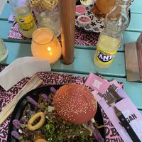 the beastie burger with onion rings  at Vegan Junk Food Bar - El Born in Barcelona