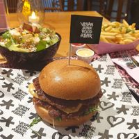 Double classic burger, side salad, and fries at Vegan Junk Food Bar - El Born in Barcelona