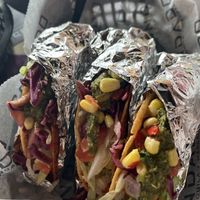 Firecracker shell, Rice, Beans, Thai chili tofu, lettuce, tomato, pickled cabbage, corn salsa, and Mexican chimichurri   at Condado Tacos - Polaris  in Columbus