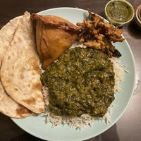 Garlic naan, saag, samosa, rice, pakoras, and the mint chutney and tamarind sauce for dipping.   at Taste of India in Rockaway Beach