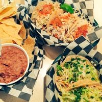 Vegan fish and Vegan Chicken tacos with chips and a side of refried beans at Pelon's Baja Grill in Norfolk