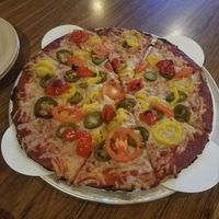 Gluten free crust with vegan chz, tomato, jalapeno,  peppadew peppers, and banana peppers at Rafferty's Pizza in Nisswa