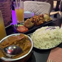 Chicken masala, 1 portion of rice, onion bhajis, samosas. The chicken was very realistic in texture. The sauce rich and tasty    at The Vegan Indian in Amsterdam