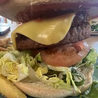 Burger and chips, moving mountainous burger and we paid extra for some ‘bacon’ which was tempeh. Not sure what cheese they used but it was great tasted likeAmerican cheese slic at Thrive in Cambridge
