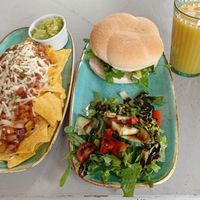 Nachos with guacamole, Chick'n burger, salad and orange juice at Thrive in Cambridge