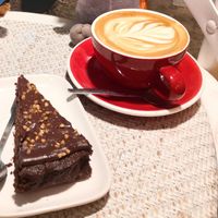 Oat flat white and cake. at Cafe 1802 in Rennes