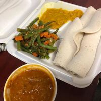 Lentil stew, green beans & carrots, split pea stew and injera. at Hana Ethiopian Cafe in Fredericton