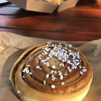 Vegan cinnamon bun (backround: non-vegan bacon sandwich)  at Brauð & Co in Reykjavik