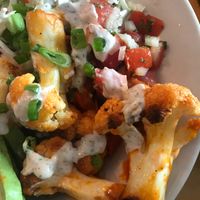 Buffalo cauliflower over rice/beans with avocado, salsa and coleslaw.   at Veg in Sarasota