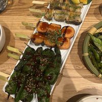 Top to Bottom: mushrooms skewers, sweet potato skewers, pardon peppers. Grilled edamame on the side.  at Sticks N Sushi in London