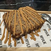 Banana bread with pb drizzle   at MYLK in Doha