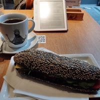 Vegan charcoal bread with vegan cheese, hummus, paprika and pickles. And a cup of filter coffee for 5 euro at R&B in Ljubljana