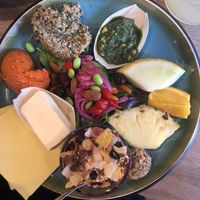 Vegan brunch with bread, paprika spread, hummus, pesto, salad, vegan butter, cheese and yoghurt, fruit and a date dessert  at Penny Lane Cafe in Aalborg