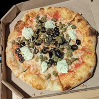 Pizza with olives and capers at Herbívoro- Chapinero in Bogota