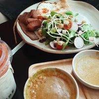 All american breakfast, fresh carrot, apple and ginger juice and left overs from pork satay. at VIBE Coffee & Plant-Based Food in Bangkok