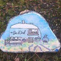 The caravan painted on a pebble at Be Kind The Vegan Coffee Caravan in Hayle