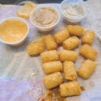 The breakfast tater totts were so crispy n delicious. I am glad. Taco bell's have beef fat so this is the place to get pure tatters. Yes to Signature dip. Garlic dip taste mustard  at V Burger in Calgary