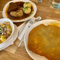 Kümmelbraten, potato salad, and schnitzel at Velani in Vienna