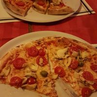 Vega pizza with vegan cheese mushrooms ans cherry tomato at Pizzeria Napoli in Kamnik