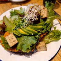Vegan toast with pumpkin, avocado, smoked tofu and salad at Kitchen Paris in Paris
