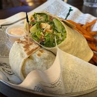 Vegan ceaser wrap with beyond chicken strips in it and simulated bacon bits with a side of sweet potato fries and vegan dip at Shepherd's Pub in Elora