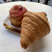 vegan croissant with strawberry flavour and a normal one   at Charlotte Croissanterie in Trieste