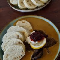 Czech dumplings with cream and cranberries at Shromaždiště in Prague