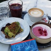 Avocado bread, whipped berry porridge, great cappuccino, berry smoothie at Karl Fazer Cafe in Helsinki